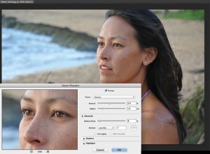 A woman stands in front of an ocean beach scene, with a photo-editing window overlayed, showcasing an enlarged close-up of her face and adjustment sliders.